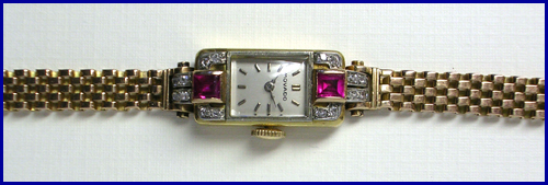 Ladies very small Movado wrist watch, circa 1935.
			Eighteen karat gold case and bracelet set with rubies and
			diamonds.