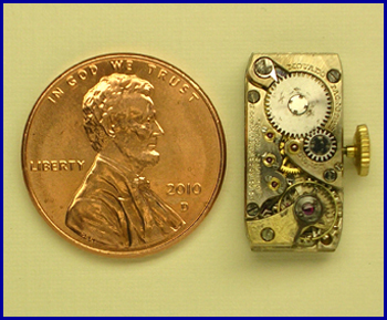 Movado caliber 9M ladies watch movement compared in size to United States one cent coin.